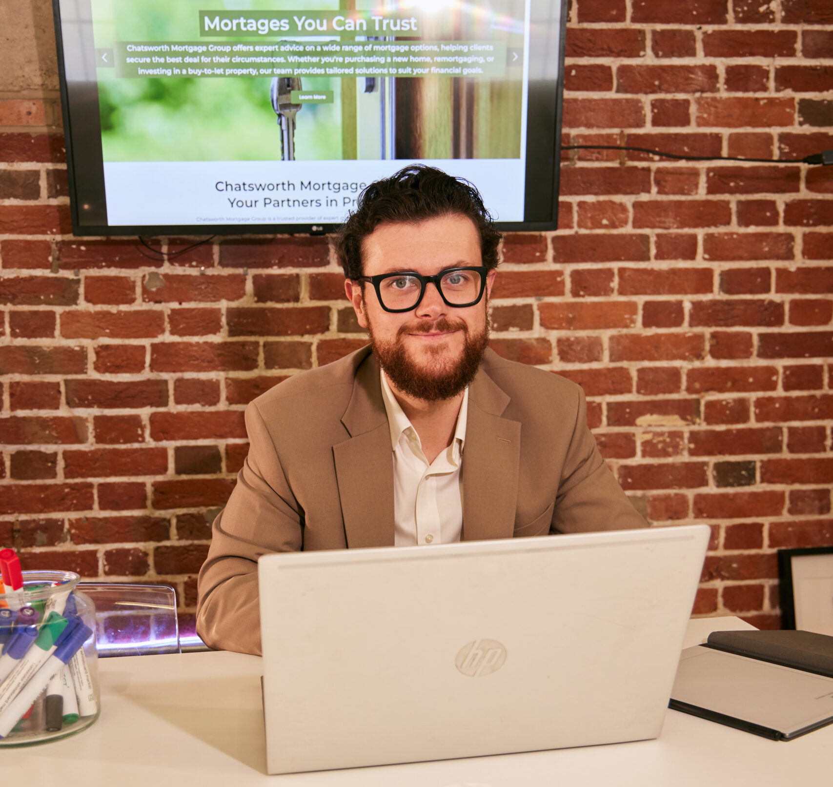 Josh Halsey MD of Chatsworth Mortgage Group Sat At Desk With Laptop - First Time Buyers Mortgage Advice